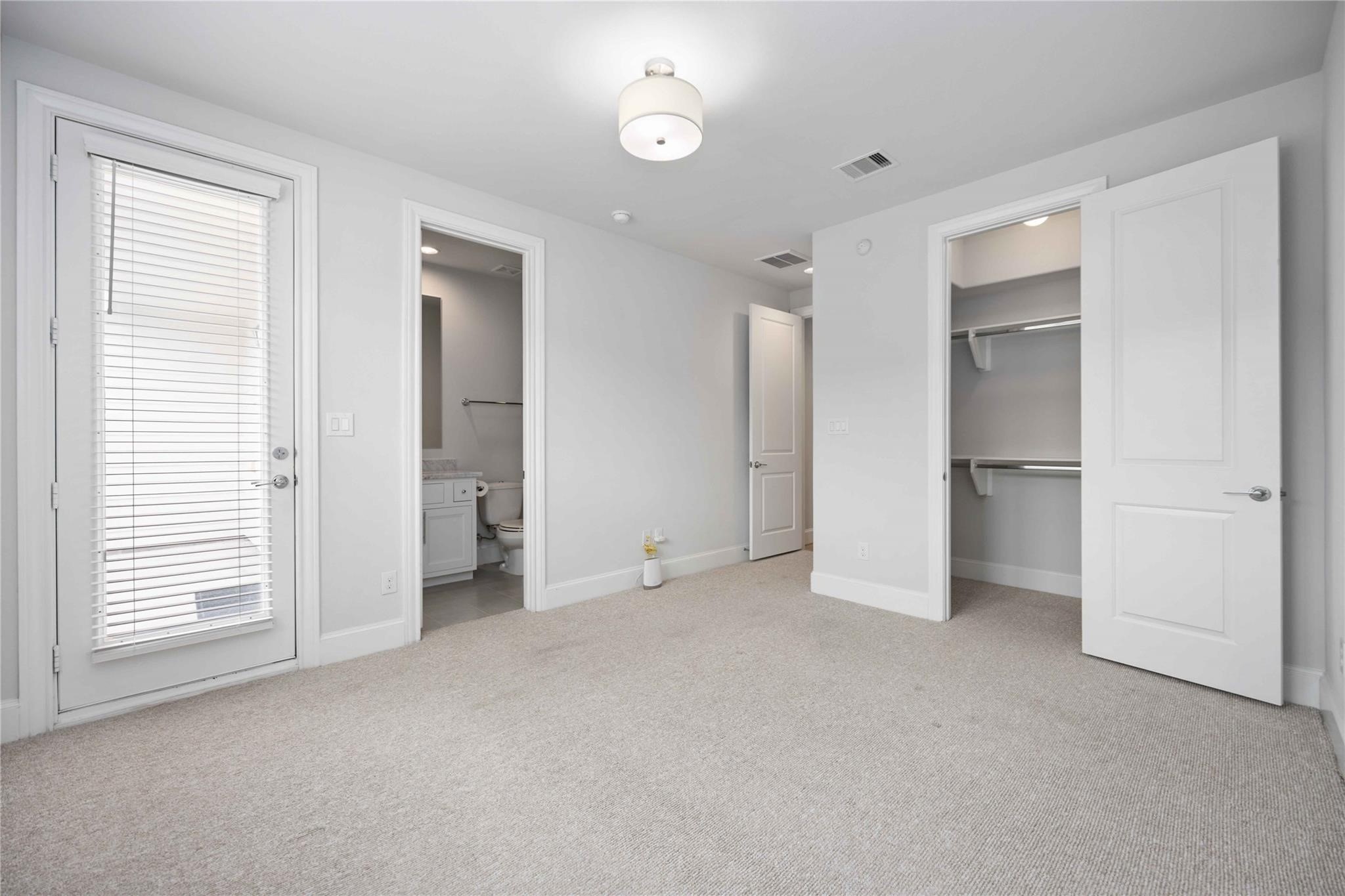 10919 Grove Tree Lane Houston, TX 77043 - Photo 8 of 43 an empty room with a window and a kitchen