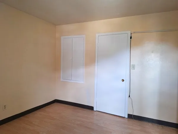 an empty room with wooden floor