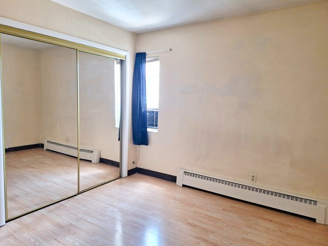 506 Main Street, Unit 3 Marseilles, IL 61341 - Photo 8 of 10 an empty room with wooden floor