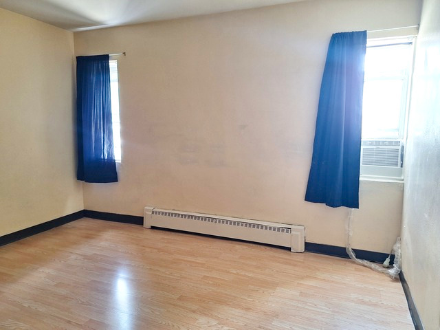 506 Main Street, Unit 3 Marseilles, IL 61341 - Photo 10 of 10 an empty room with wooden floor and windows