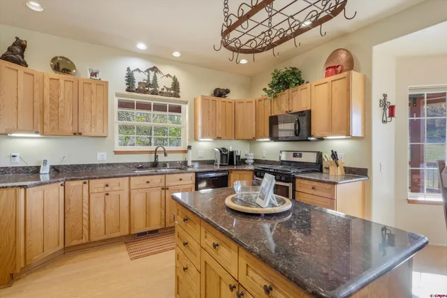 a kitchen with a sink a stove and cabinets