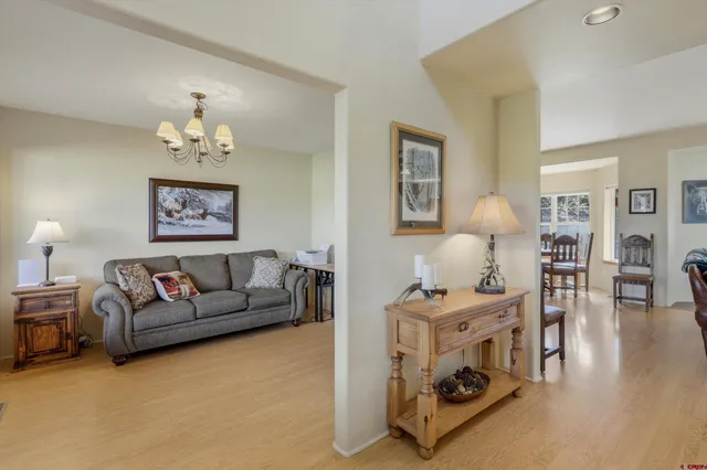 a living room with furniture and a chandelier
