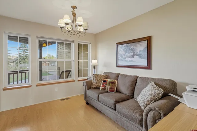 a living room with furniture and a chandelier
