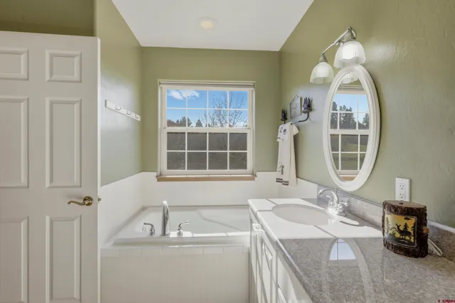 a bathroom with a sink a vanity and a mirror