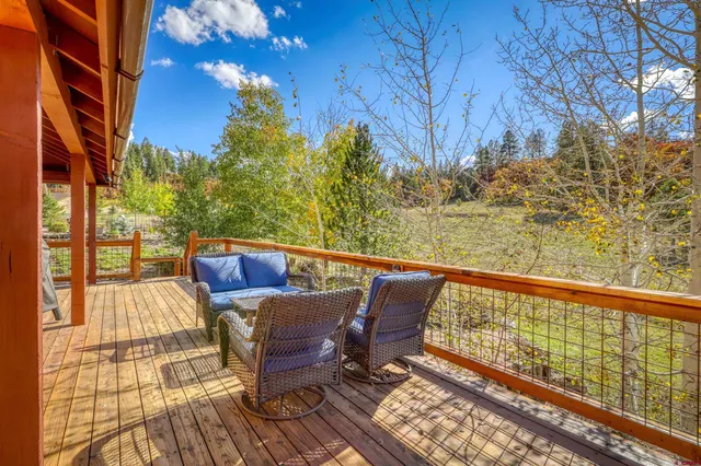 a view of a chairs and table on the deck