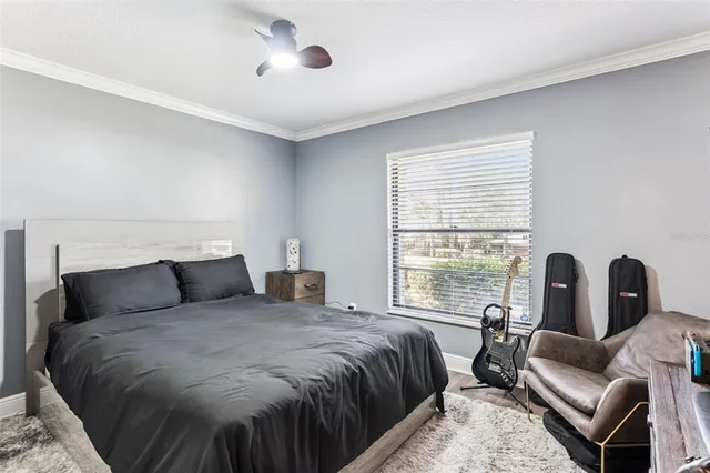 a bedroom with a bed a couch and a window