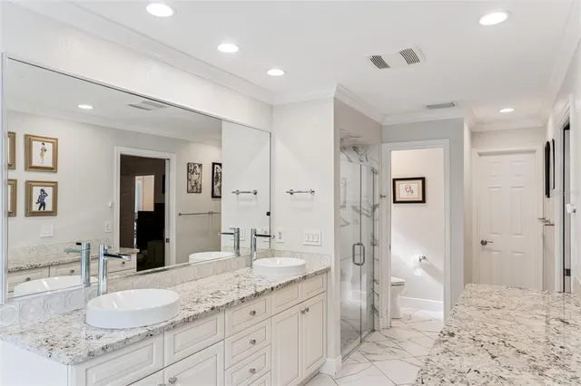 a spacious bathroom with a granite countertop sink mirror and shower