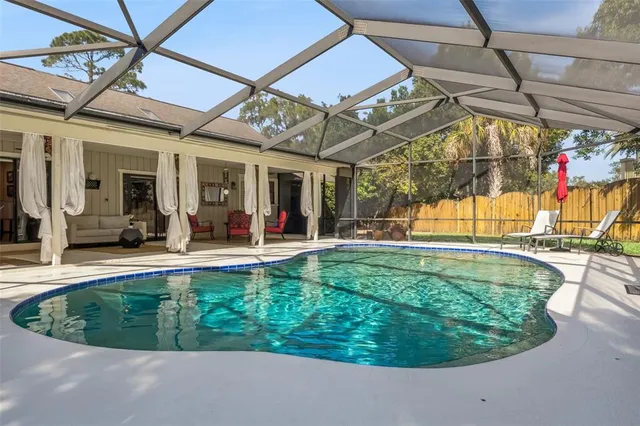a view of a backyard with a small swimming pool