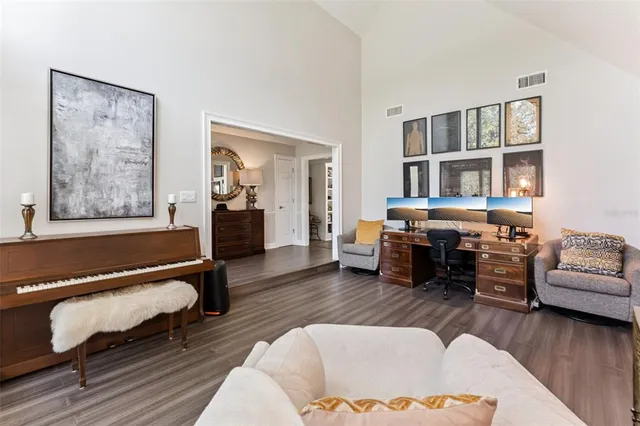 a living room with furniture and a book shelf