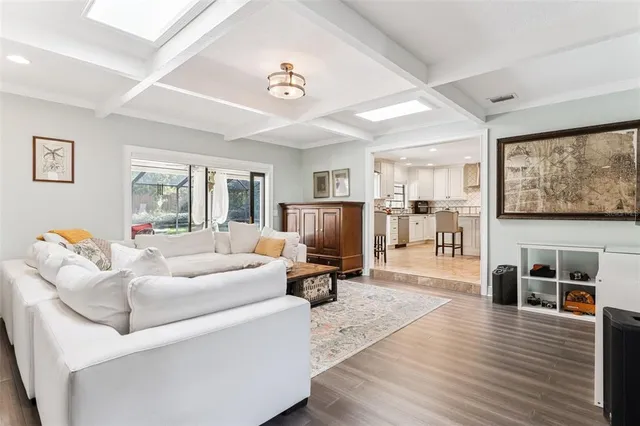 a living room with furniture and large windows
