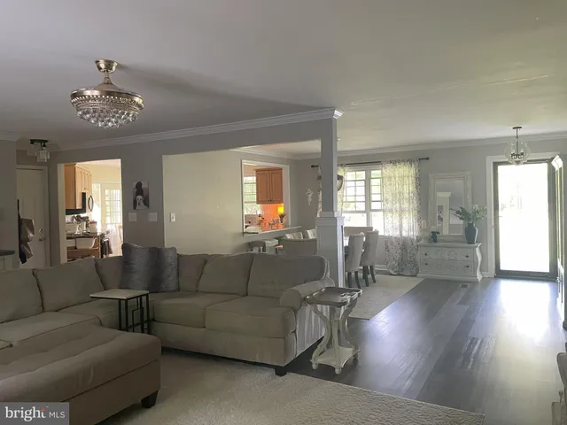a living room with furniture and a chandelier