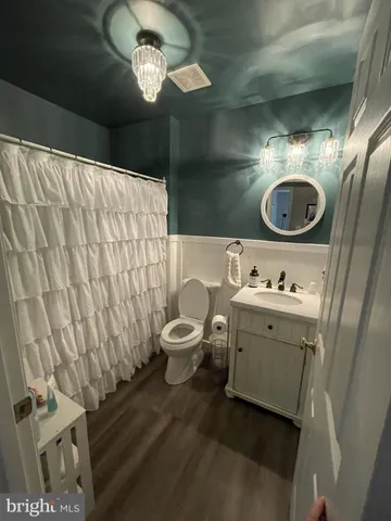 a bathroom with a toilet sink and mirror