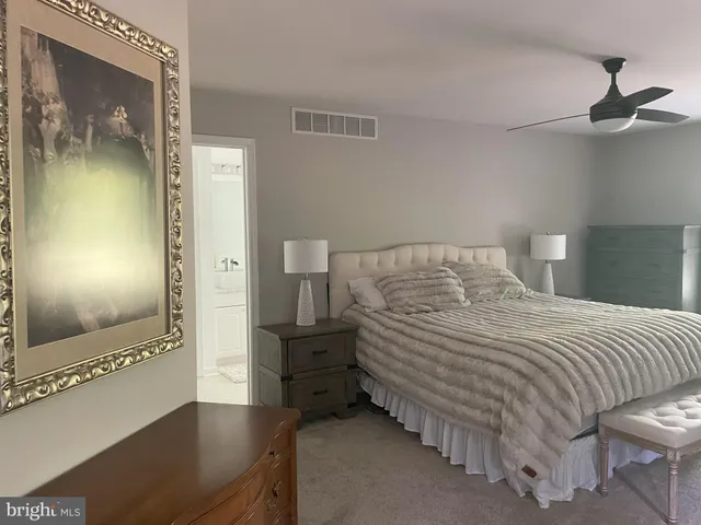 a bedroom with a bed and a mirror