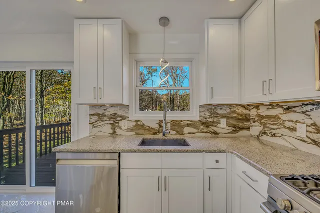 a kitchen with sink a window and cabinets