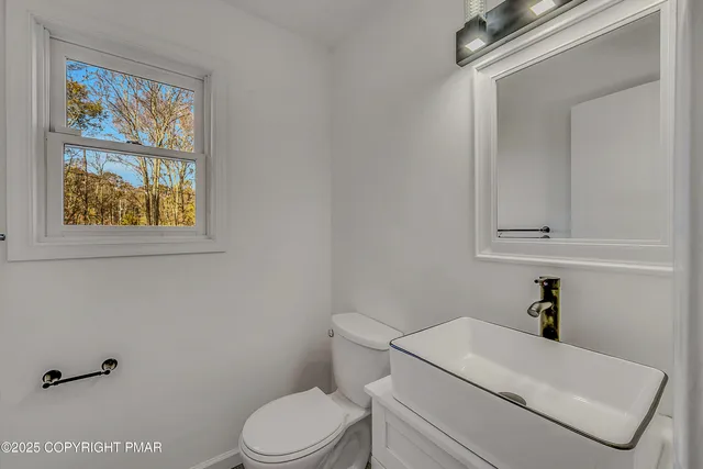 a white toilet sitting next to a bathroom sink
