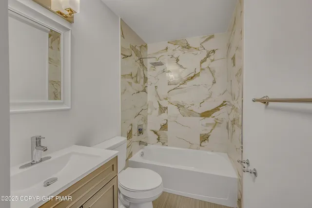 a bathroom with a sink toilet and shower