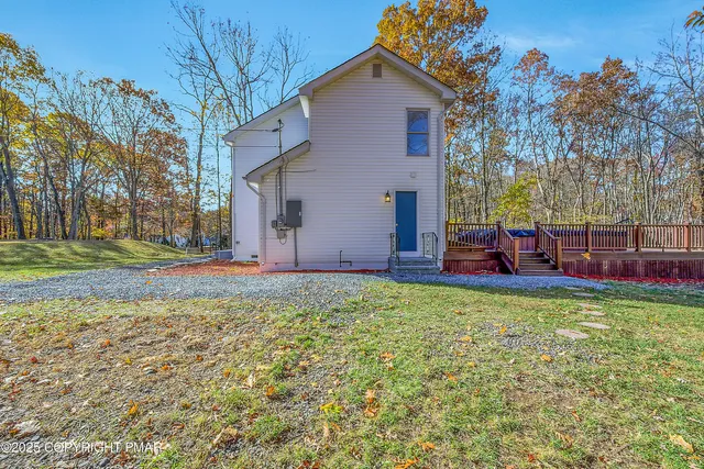 a backyard of a house with table and chairs