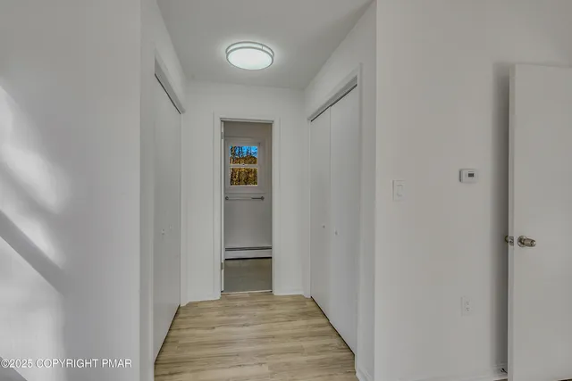 a view of a hallway with wooden floor