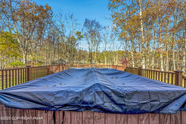 a view of a backyard with wooden fence
