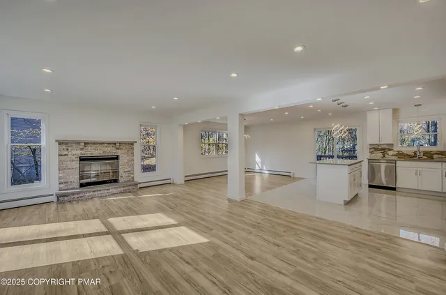 a view of a kitchen with a sink and a fireplace