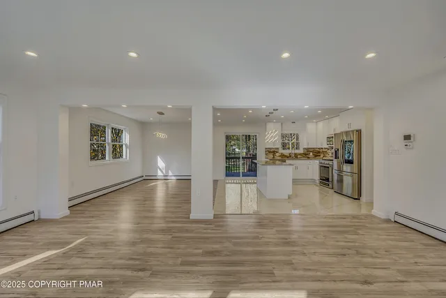 a view of a kitchen with furniture and wooden floor