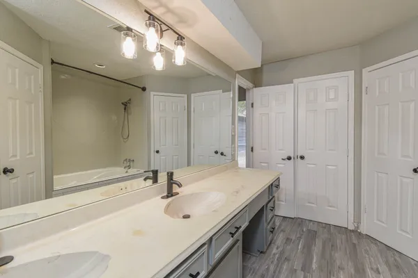 a bathroom with a sink a mirror and a shower