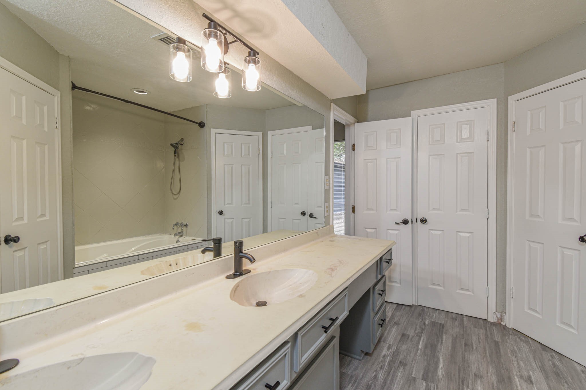 16911 Summit Oaks Lane Spring, TX 77379 - Photo 12 of 24 a bathroom with a sink a mirror and a shower