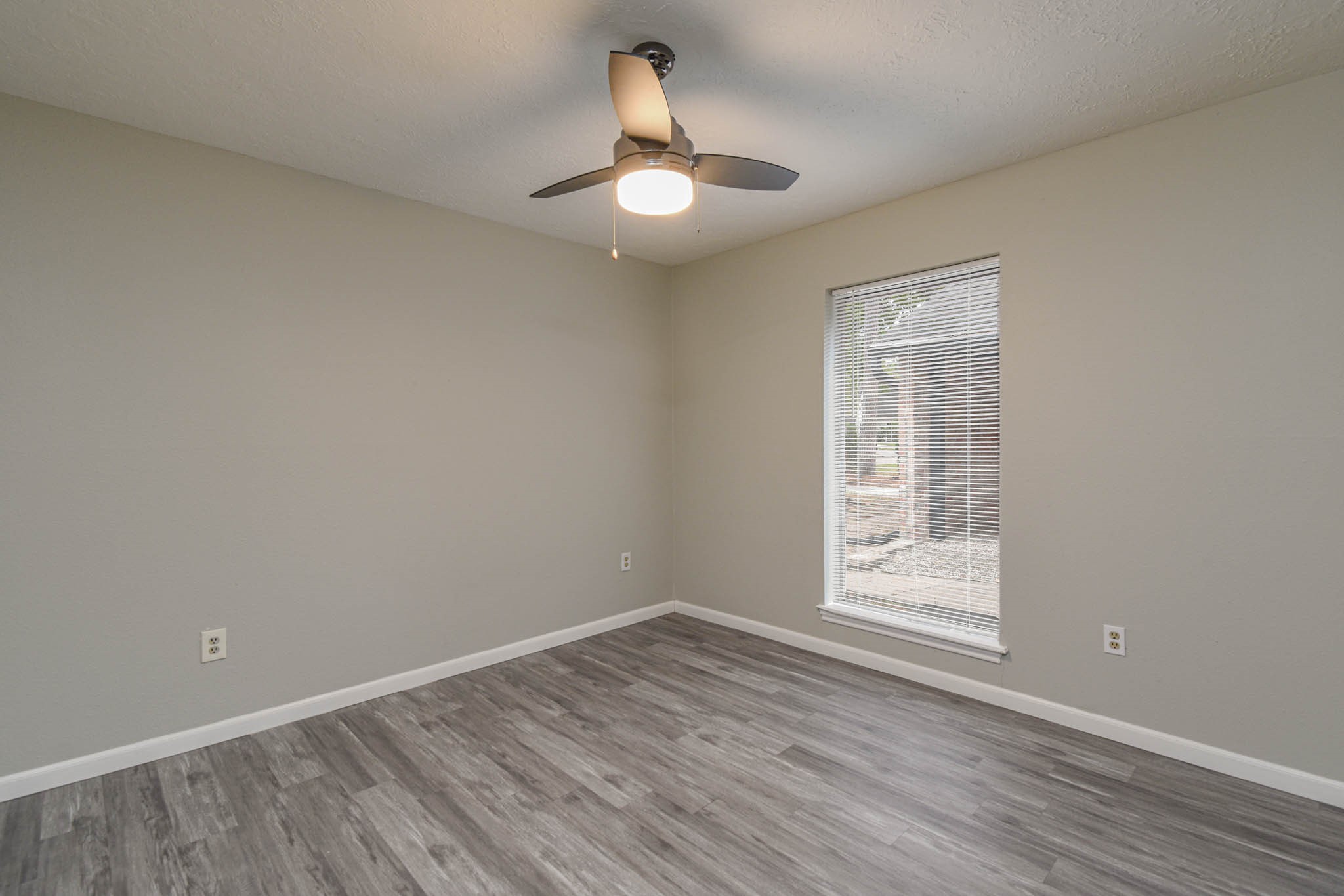 16911 Summit Oaks Lane Spring, TX 77379 - Photo 14 of 24 a view of empty room with wooden floor fan and window