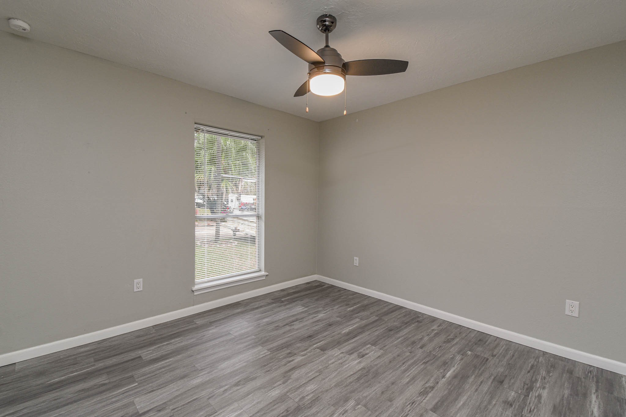 16911 Summit Oaks Lane Spring, TX 77379 - Photo 15 of 24 an empty room with wooden floor and windows