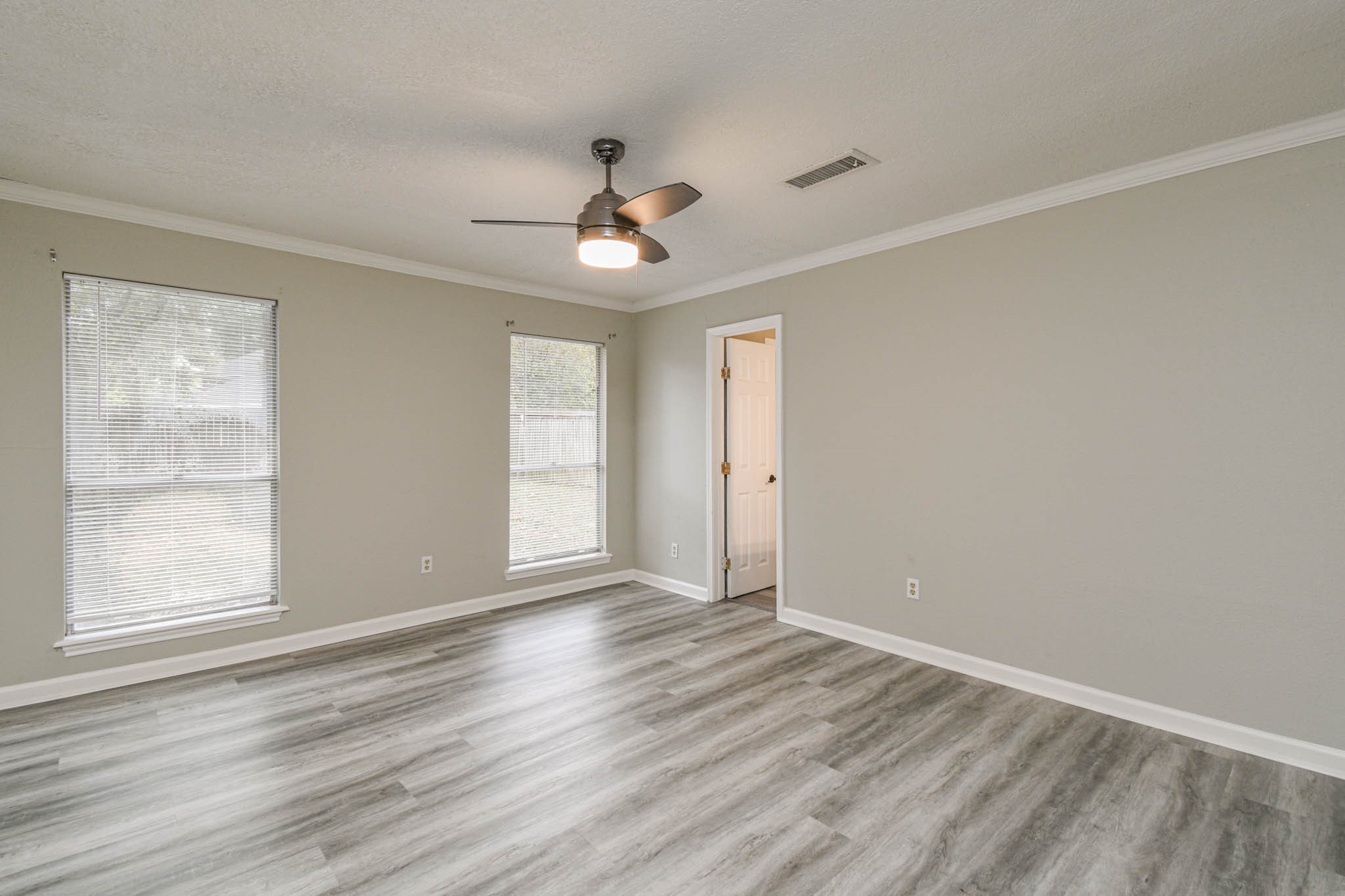16911 Summit Oaks Lane Spring, TX 77379 - Photo 18 of 24 a view of an empty room with wooden floor and a window