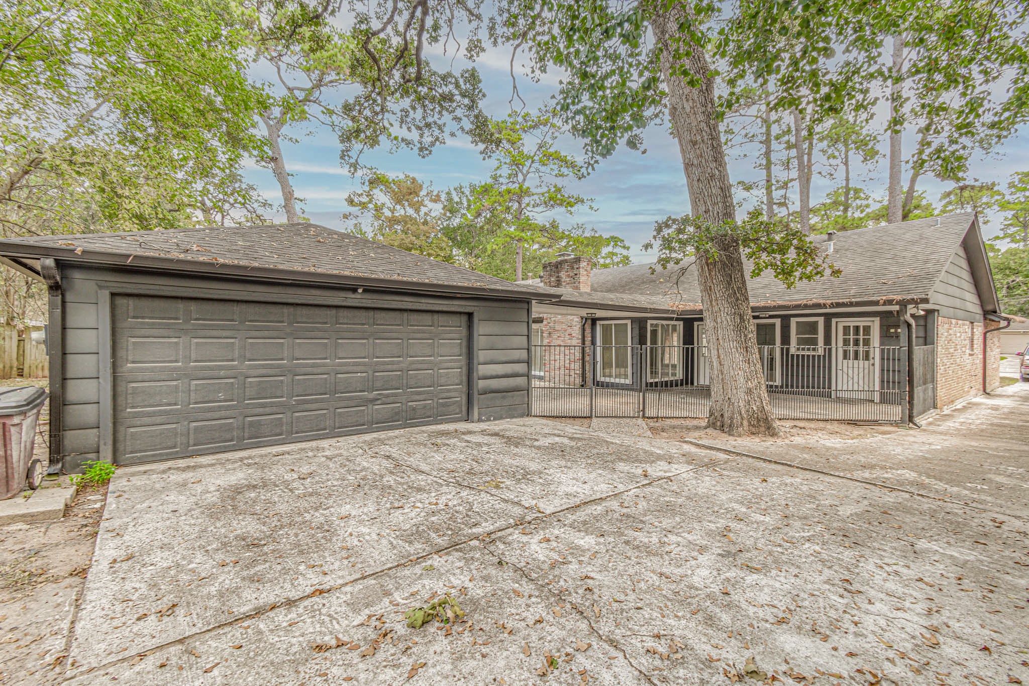 16911 Summit Oaks Lane Spring, TX 77379 - Photo 23 of 24 a front view of a house with a yard and garage