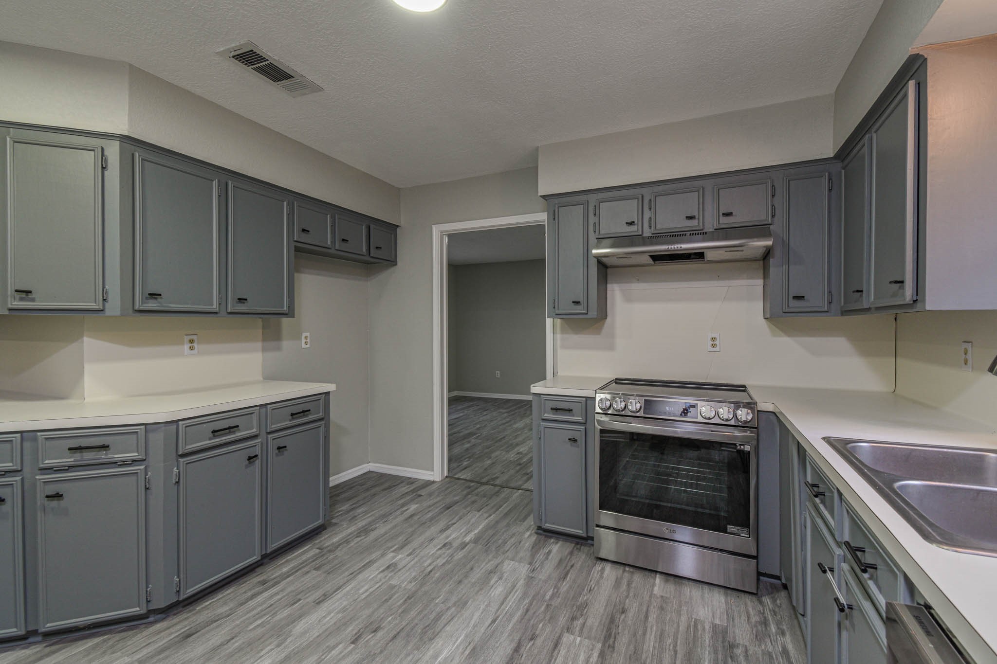 16911 Summit Oaks Lane Spring, TX 77379 - Photo 7 of 24 a kitchen with a stove and a sink