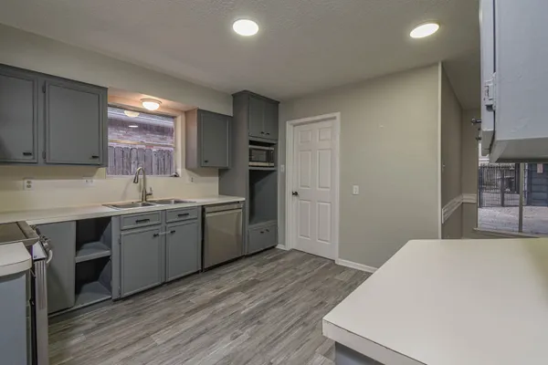 a kitchen with a sink stove and cabinets