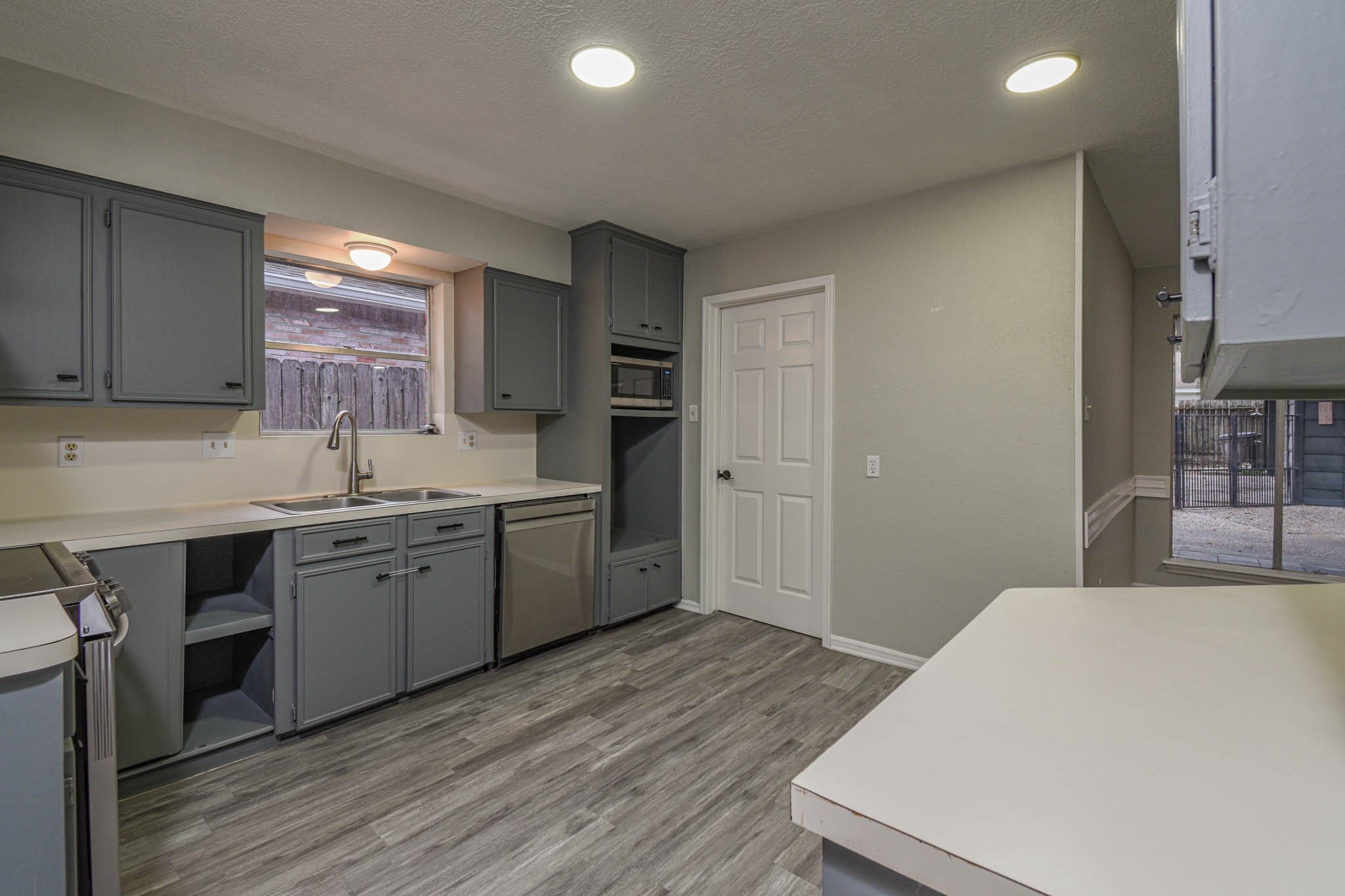 16911 Summit Oaks Lane Spring, TX 77379 - Photo 8 of 24 a kitchen with a sink stove and cabinets