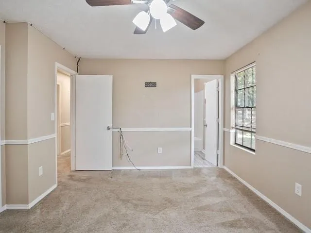 an empty room with windows and closet