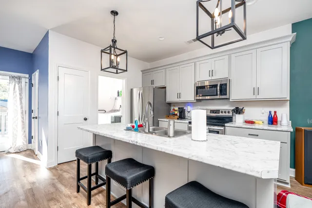 a kitchen with stainless steel appliances a sink refrigerator and microwave