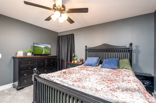 a bedroom with a bed and a dresser