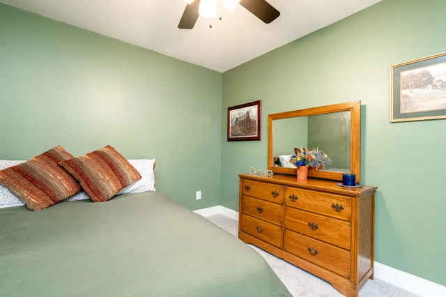 a room with a bed and a dresser