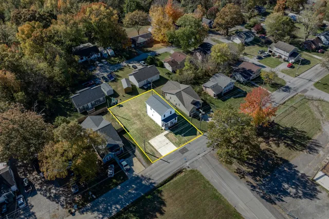 an aerial view of house with a yard