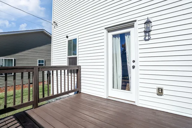 a view of a balcony with wooden floor