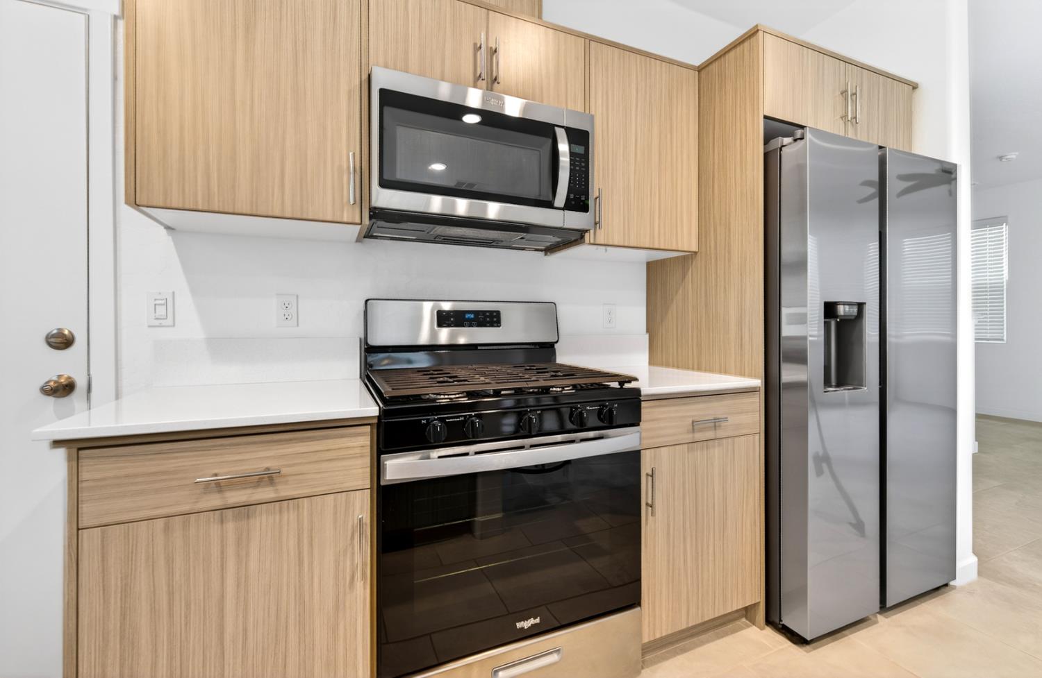 317 Talus Way South Madera, CA 93636 - Photo 16 of 61 a kitchen with stainless steel appliances granite countertop a stove microwave and refrigerator