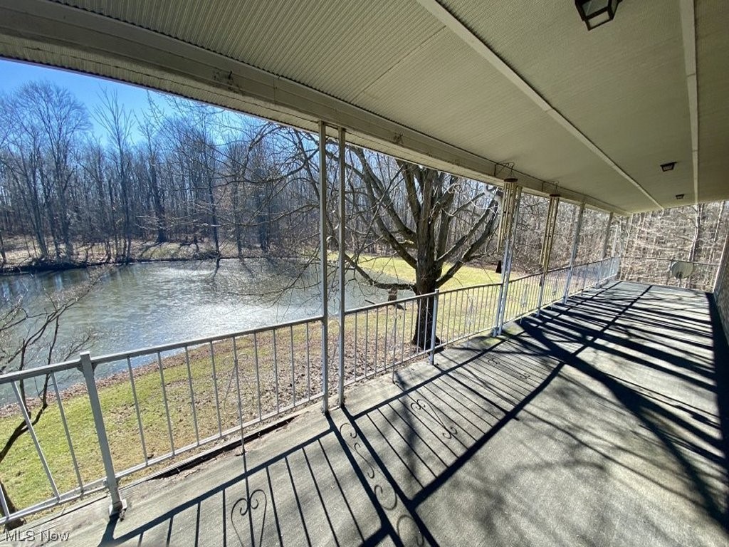 9520 Stone Road Litchfield, OH 44253 - Photo 20 of 22 Deck with a water view and a lawn