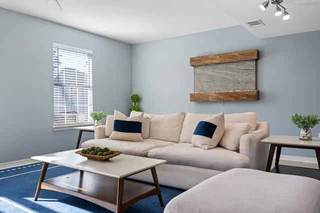 a living room with furniture and a potted plant