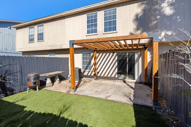 a view of a backyard with a patio and outdoor seating