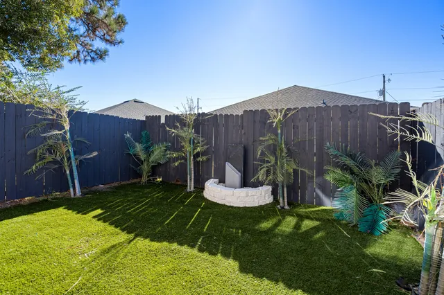 a view of a backyard with plants and a garden