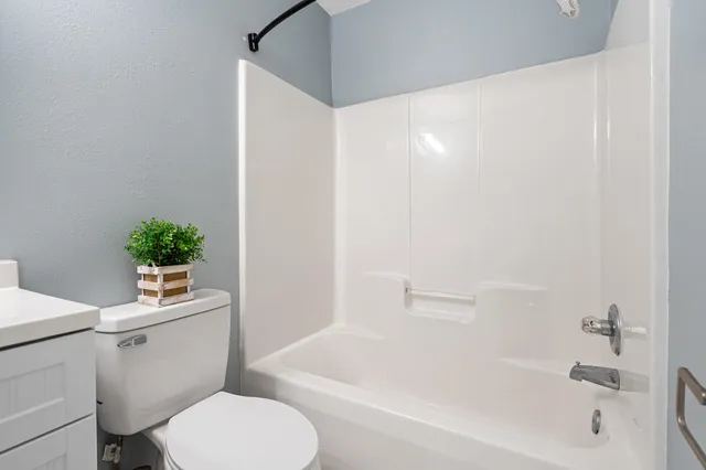 a view of room with wooden floor and ceiling fan