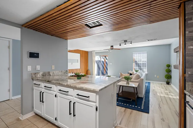 a kitchen with sink stove and cabinets