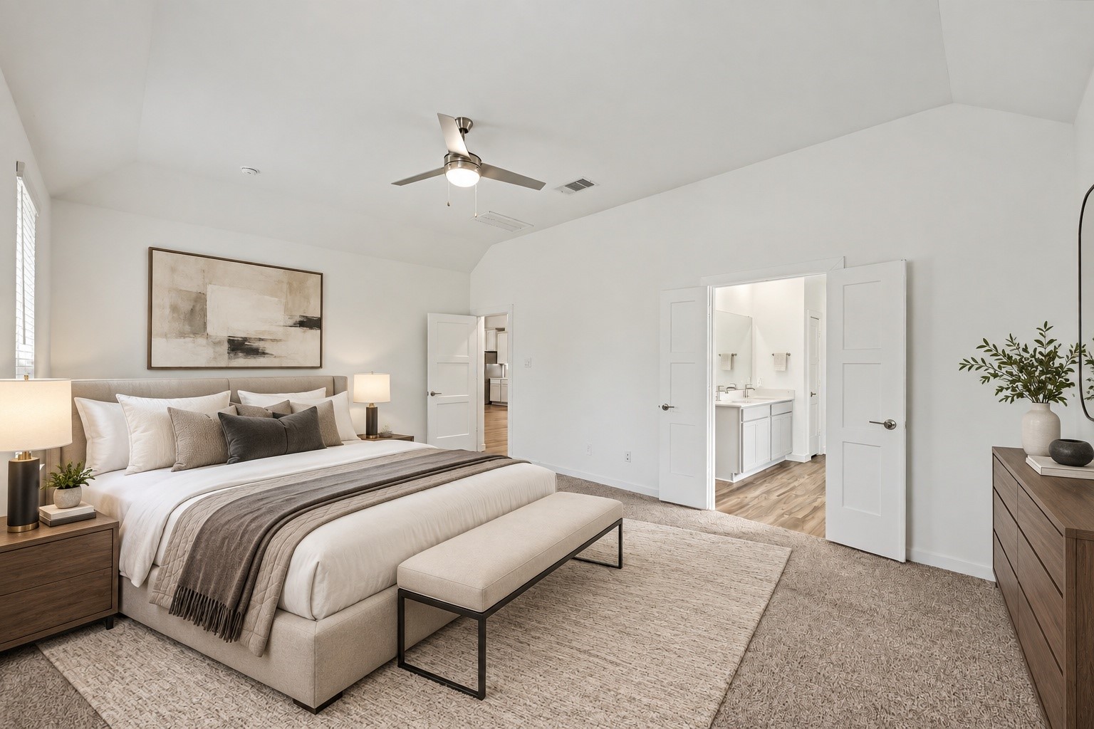 14162 Primrose Ridge Lane Conroe, TX 77384 - Photo 28 of 48 Elegant and inviting, this beautifully staged bedroom offers a serene retreat with a spacious layout, modern ceiling fan, and seamless access to a luxurious en-suite bathroom.