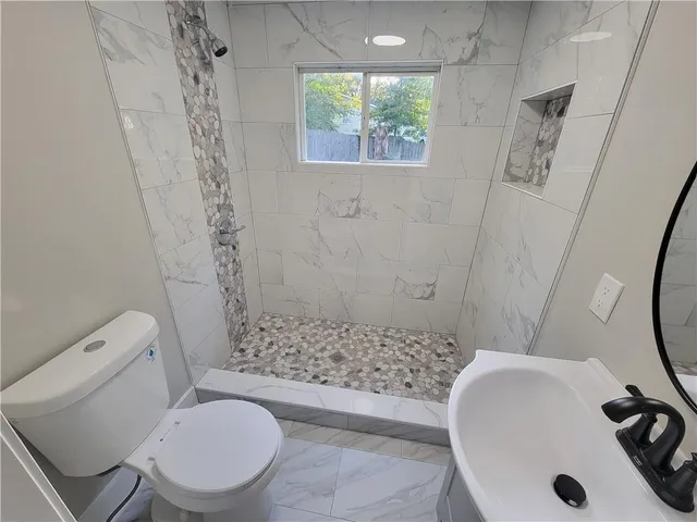 a bathroom with a sink toilet and shower