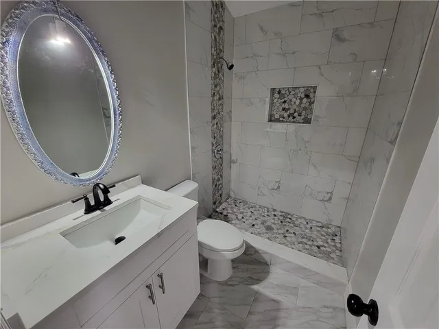 a bathroom with a sink a toilet and a mirror